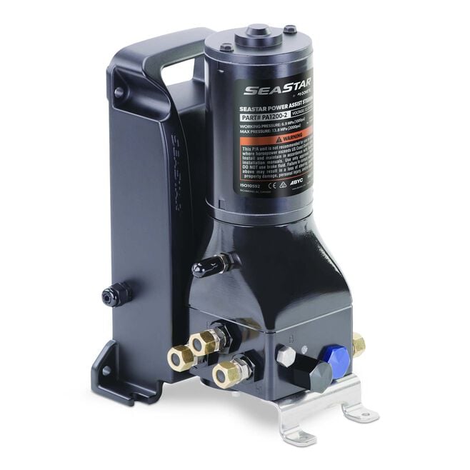 A black SeaStar Power Assist hydraulic steering pump, with visible branding and components including inlets and outlets.