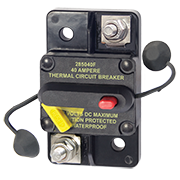 A black surface mount thermal circuit breaker with a red switch lever and a yellow wire terminal. It has text indicating the model number, amperage rating, and a warning that it is ignition protected and water resistant.