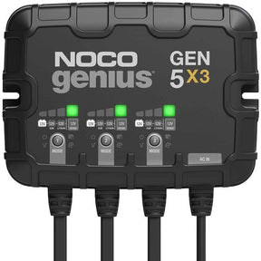 A black NOCO GEN5 x3 battery charger with three charging banks and various indicator lights visible on the front panel.